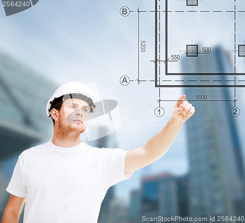 Image of male architect pointing at blueprint