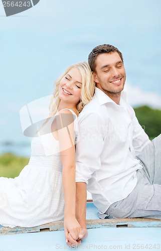 Image of smiling couple at sea side