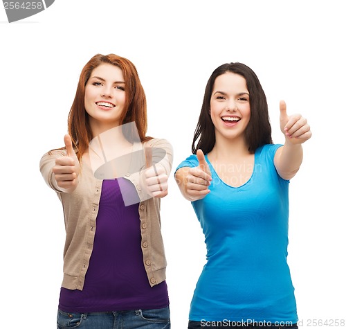 Image of two smiling girls showing thumbs up