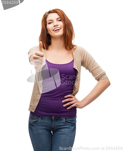 Image of smiling girl in casual clothes showing thumbs up