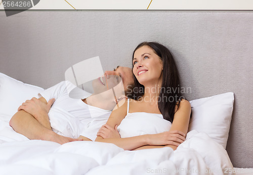 Image of happy couple dreaming in bed