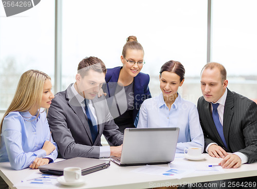 Image of business team with laptop having discussion