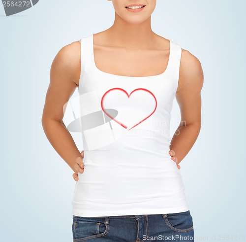Image of woman in white tank top with heart on it