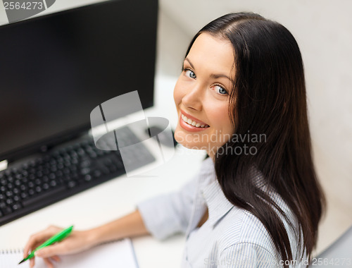 Image of smiling businesswoman or student studying