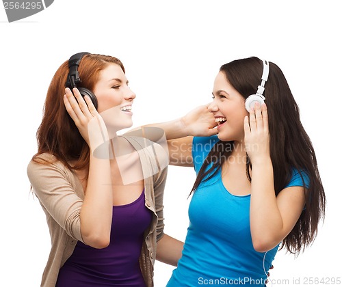 Image of two laughing girls with headphones