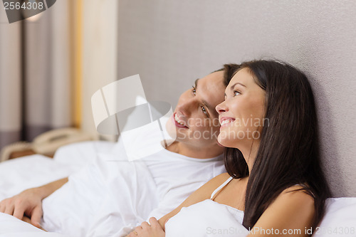 Image of happy couple dreaming in bed