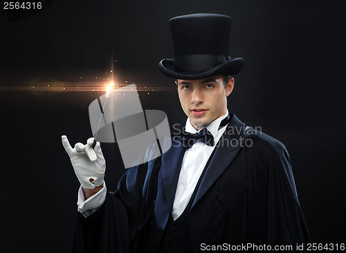 Image of magician in top hat with magic wand showing trick