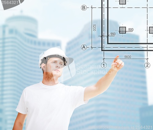 Image of male architect pointing at blueprint