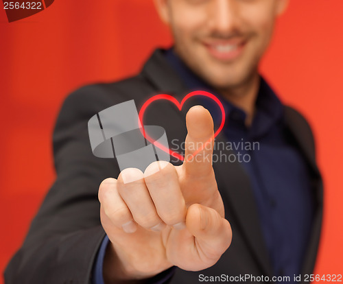 Image of handsome man in suit pressing virtual button