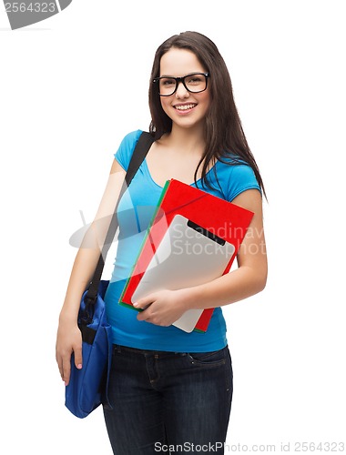 Image of smiling student with bag, folders and tablet pc