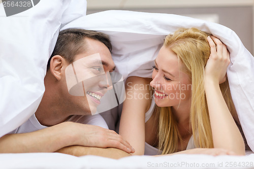 Image of happy couple sleeping in bed