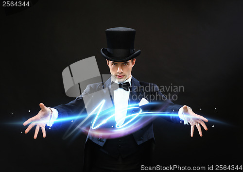 Image of magician in top hat showing trick