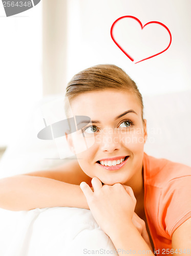 Image of smiling woman lying on the couch