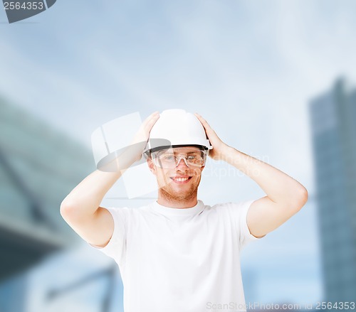 Image of male architect in helmet with safety glasses