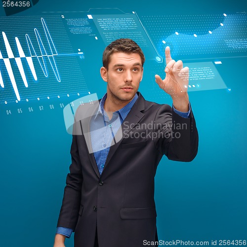 Image of businessman working with imaginary virtual screen