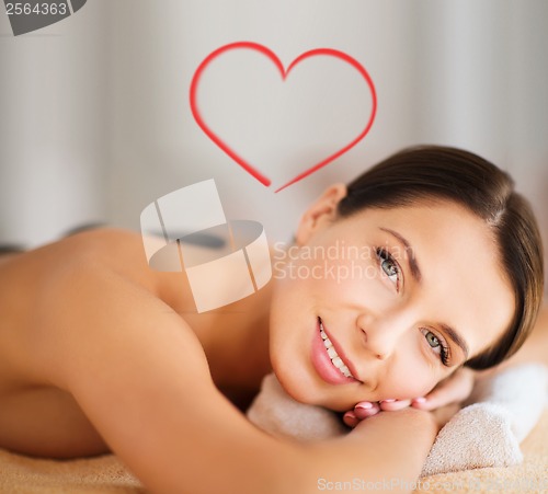 Image of beautiful woman in spa salon with hot stones