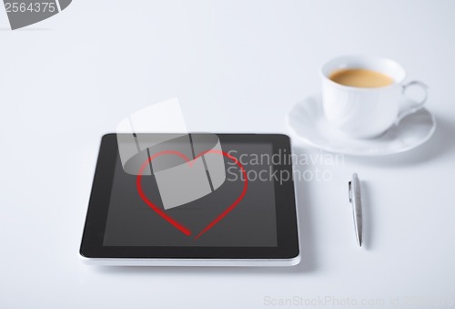 Image of tablet pc and pen with cup of coffee