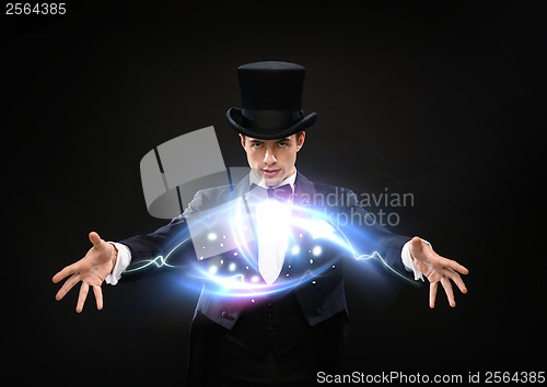 Image of magician in top hat showing trick