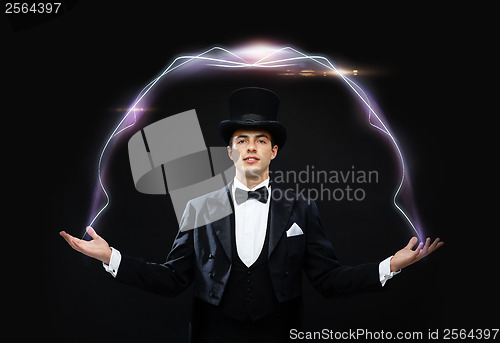 Image of magician in top hat showing trick