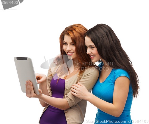 Image of two smiling teenagers with tablet pc computer