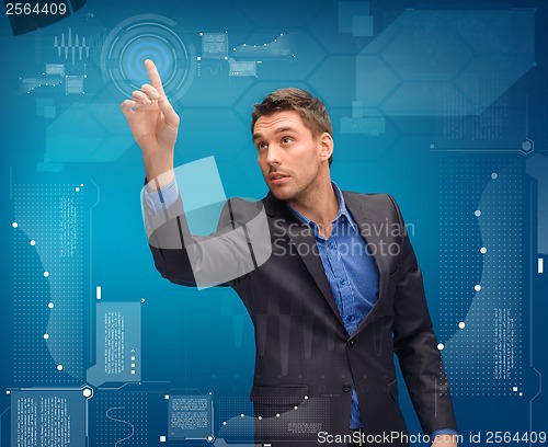 Image of businessman working with imaginary virtual screen