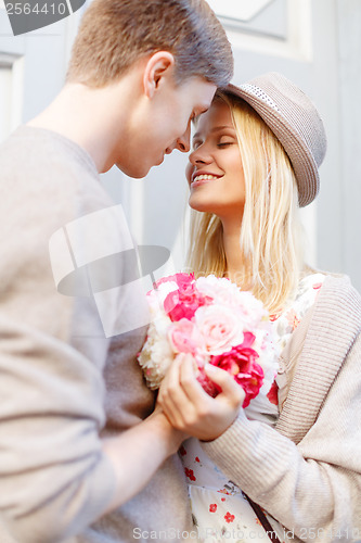 Image of happy couple with flowers in the city