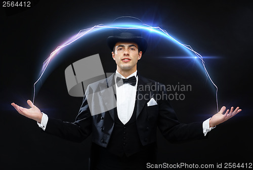 Image of magician in top hat showing trick