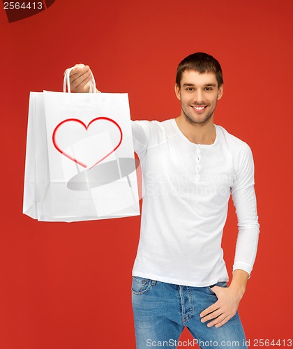 Image of smiling man with shopping bags and heart on it