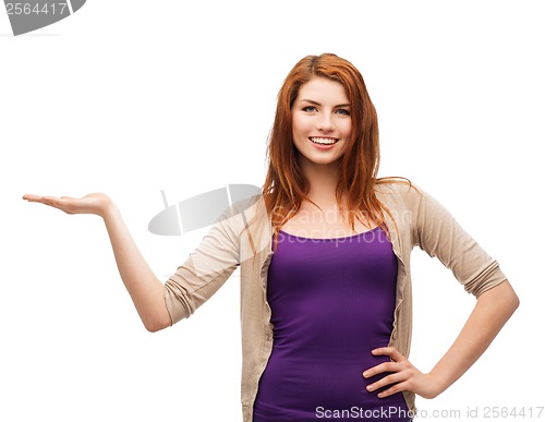 Image of teenager holding something on the palm of her hand