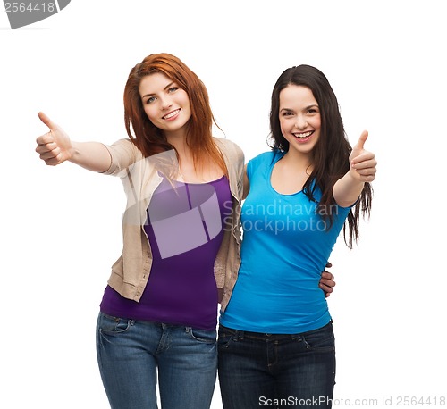 Image of two smiling girls showing thumbs up