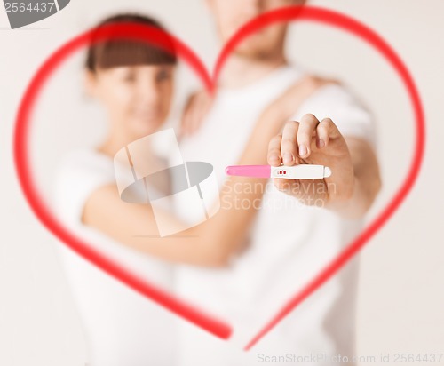 Image of woman and man hands with pregnancy test
