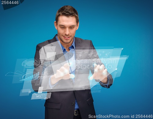 Image of businessman working with imaginary virtual screen