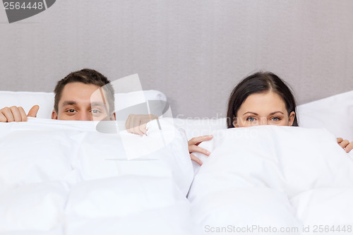 Image of happy couple sleeping in bed