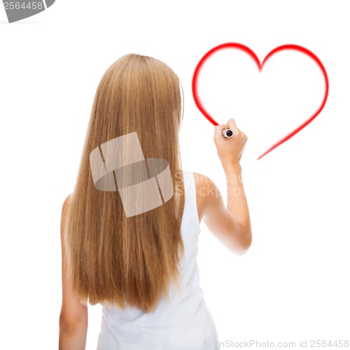 Image of girl in shirt drawing heart on virtual screen