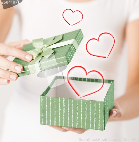 Image of woman hands with gift box