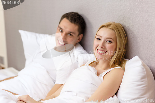 Image of happy couple sleeping in bed