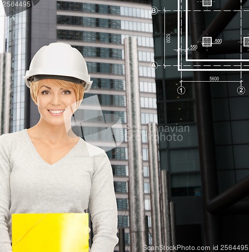 Image of female contractor in white helmet with files