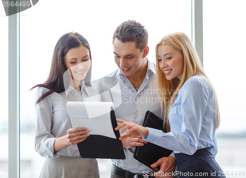 Image of business team looking at clipboard