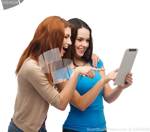 Image of two smiling teenagers with tablet pc computer