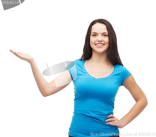 Image of teenager holding something on the palm of her hand