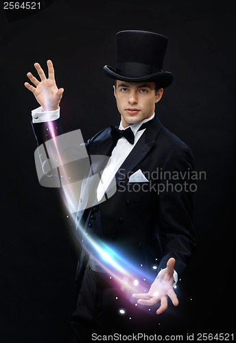 Image of magician in top hat showing trick