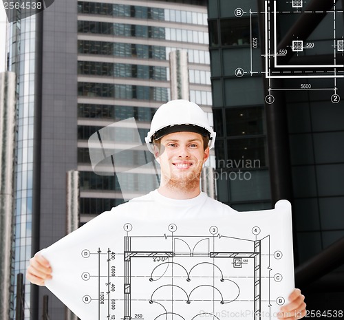 Image of male architect in white helmet with blueprint