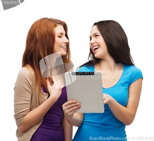 Image of two smiling teenagers with tablet pc computer