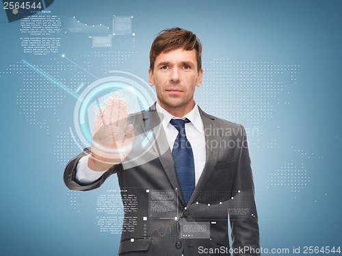 Image of attractive buisnessman working with virtual screen