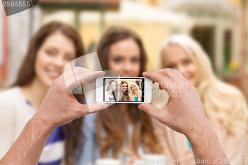 Image of close up of hands taking picture with smartphone