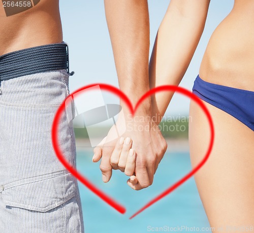 Image of man and woman holding hands