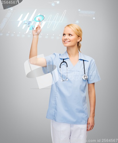 Image of smiling doctor or nurse pointing to cardiogram