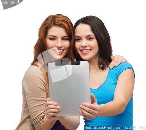 Image of two smiling teenagers with tablet pc computer