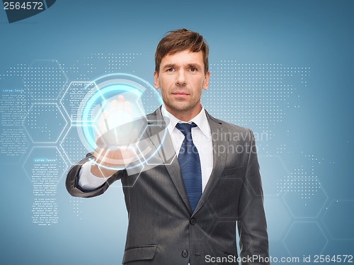 Image of attractive buisnessman working with virtual screen