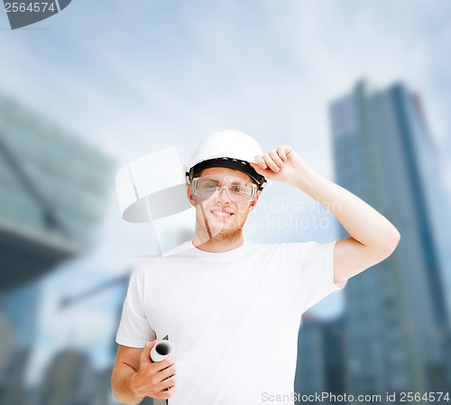 Image of male architect in helmet with blueprint